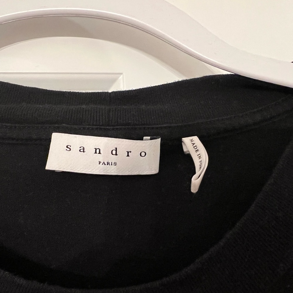 Sandro black T shirt with velvet print on by chest pocket.